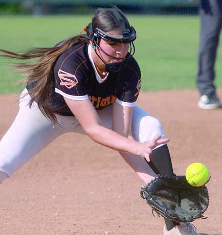Third baseman Brenley Bujnoch gloves a Lady Hornet grounder for an out. Sticker Photo By Darrell Vyvjala