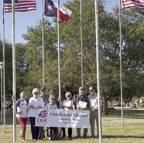 DAR and SAR representatives with a banner for flag display recognition, which was awarded to Dale and Doreen Alexander for December, are (from left) Donna Pustejovsky, Connie and Vernon Dittrich, Nelma Strey, Judy Zachmeyer, Glen Strey and David Zachmeyer