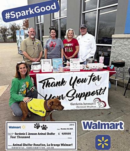 Walmart in La Grange was the location for a fundraising and awareness event hosted by the Gardenia E. Janssen Animal Shelter and also made a $4,000 contribution to the shelter. Shown are (front)Antoinette Joplin, GJAS volunteer with Hazelnut (available for adoption); (back row, from left) Kevin Ickles, Walmart store manager; Teresa Brown, GJAS executive director, Cindy Klosel, GJAS board director; and Frank Reichert, GJAS board president.