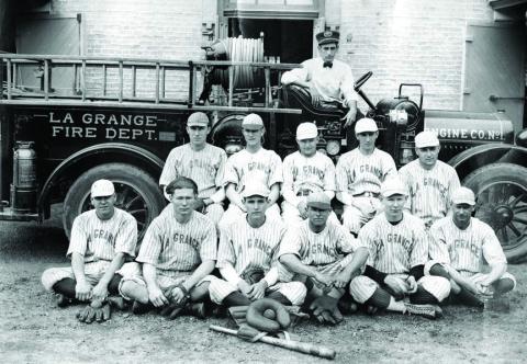 The La Grange Fire Department’s baseball team poses in front of an early fire engine and the Old Casino Hall, which had recently been converted from La Grange High School to a fire station. None of the men have been identified.