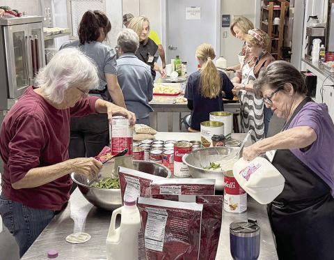 Volunteers are busy cooking the Thanksgiving feast for Senior Connections.