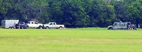 Members of the Austin County Regional Special Response Team approach the stolen vehicle and trailer. Photo Courtesy of the Fayette County Sheriff’s Department