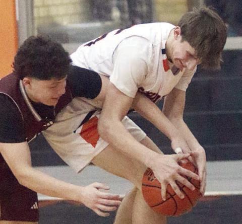 In his first varsity action, freshman William Eudy wrestles the ball away from a Bulldog in the fourth quarter. Sticker Photo By Darrell Vyvjala