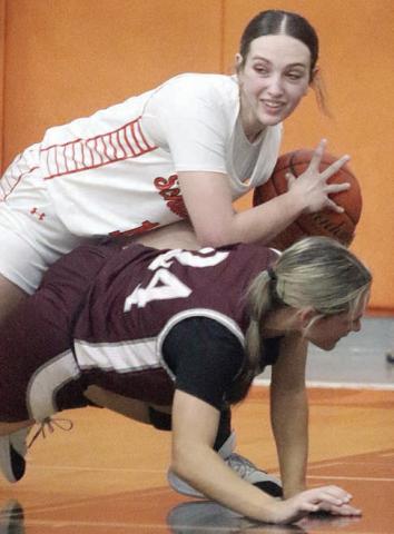 Grace Schramek takes the ball away from a Lady Bulldog in the second quarter last Tuesday. Sticker Photo By Darrell Vyvjala