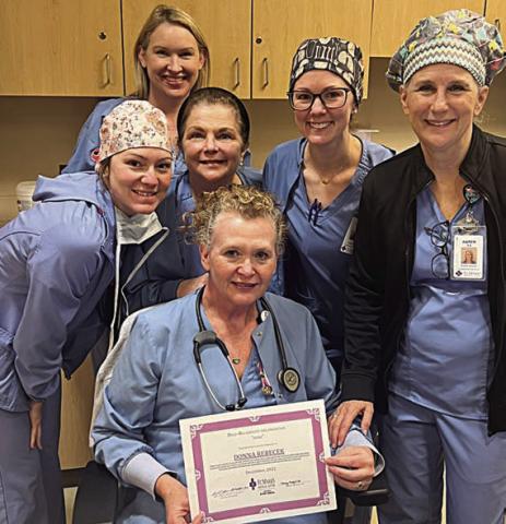 Donna Rebecek (front), BSN, RN, CEN Surgical Services, December 2022 St. Mark’s HeRO award winner, surrounded by her teammates (back, from left) Meghan Koranek, RN, Surgical Services; Jenifer Leyendecker BSN, RN, CNOR Director of Surgical Services; Geralyn Neely, BSN, RN, Surgical Services; Lensey Spradley, BSN, RN, Surgical Services; and Karen Kilian, RN, Surgical Services.