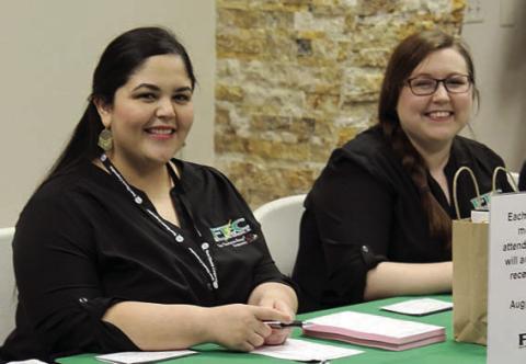 Fayette Electric Cooperative employees Diana Torres and Amy Rackley greet customers as they register at the 2019 annual meeting. This was the last time that FEC's annual meeting was held in-person.
