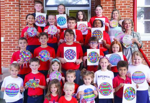A disco ball theme helped promote the Parents As Teachers Day observance, and area students were asked to decorate disco ball artwork. Shown are St. Rose of Lima Catholic School students displaying their creations.
