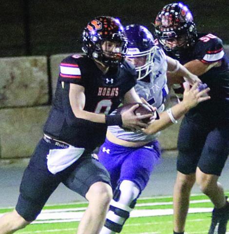Owen Brenek uses a block from Jayden Olmos to get free for a 56-yard run in the first quarter. Sticker Photo By Layne Vyvjala