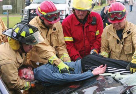 SVFD personnel (from left) Travis Leihardt, Josh Berckenhoff, Caleb Geissen, and Mike Czimskey remove the “deceased” body of Kael Baumgarten from one of the vehicles. Sticker Photo By Darrell Vyvjala