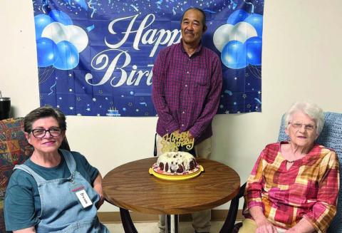 June birthdays were celebrated, with (from left) Brenda Ray, Joseph Collins and Clara Christ on hand for the photo with the cake baked by a secret baker.