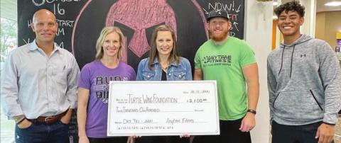 $2,100 DONATED – On hand for the presentation of a donation of $2,100 from the Anytime Fitness Dry-Tri to Turtle Wing Foundation were (from left) Chip and Kim Bubela, Anytime Fitness owners; DeeAnn Hooper, Turtle Wing founder and president; Mitch Bailey, Anytime Fitness Schulenburg club manager; and Jean Gonzales, personal trainer