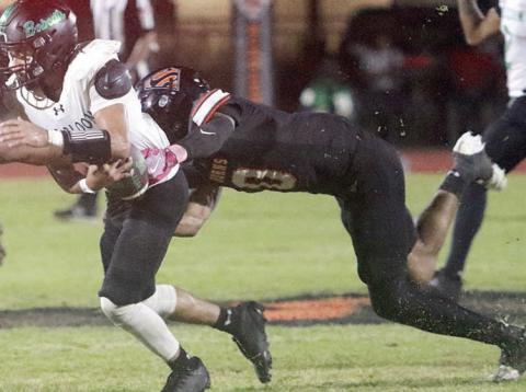 Jakele Houston corrals quarterback Amari Gardner for a sack on fourth down in the second quarter. Sticker Photo By Brandt Vyvjala