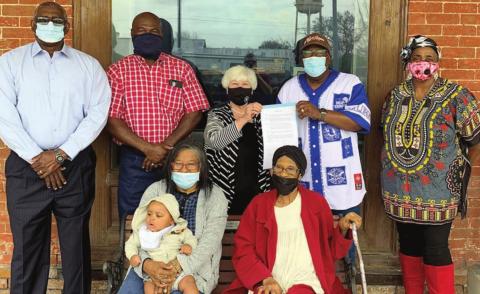 BLACK HISTORY MONTH RESOLUTION – Gathering to display the resolution for Black History Month are (front row, from left) Autrey Thomas with Jaceon Lara in her lap, Lois Carroll, (back row) Willis Adams, Greg Thomas, Mayor Elaine Kocian, Rev. Andrew Stafford and Marsha Caine.