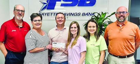 Fayette Savings Bank and Led + Fed representatives on hand for the donation presentation were (from left) Mike Olle and Cheryl Brossmann, FSB; Nathan and Jenny Neiser, Led + Fed founders; Alycia Konvicka, Led + Fed board member; and Brad Tumis, FSB.
