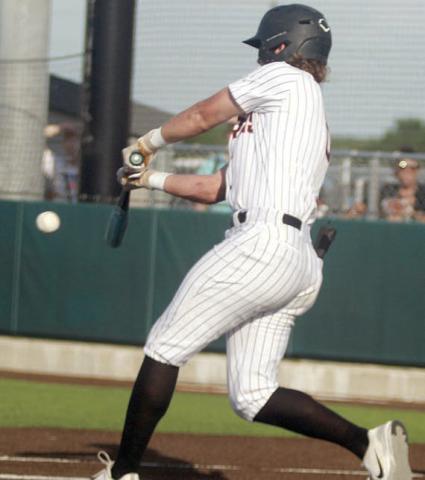 Aaron Janecek connects for an RBI in game one. Sticker Photo By Darrell Vyvjala
