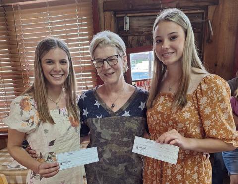 Scholarship recipients Jordan Whitley (left) of Hallettsville and Delaney Turlington (right) of Weimar are congratulated by Hermann Sons Life Lodge 14 scholarship chair Mary K. Seifert (center).