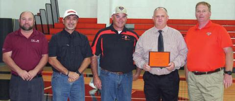 School officials present plaque to coach Zapalac
