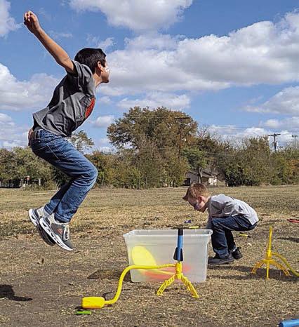 Students experiment with the principal of air pressure using stomp rockets.