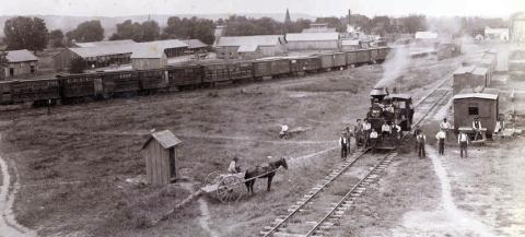 Circa 1895 photograph of the M.K.T. rail yard on the eastern end of La Grange (vicinity of 600th block East La Fayette Street) looking south with the bluff in the distance. Louis Melcher captured this view from the roof of the M.K.T. freight depot. Train cars, warehouses, elevated tanks and open sheds like those used by lumberyards are visible (present day Farmer’s Lumber Co.).