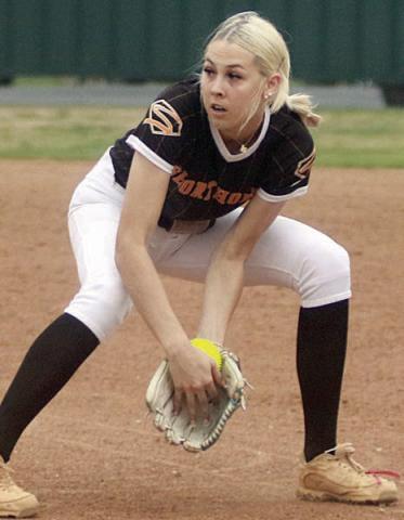 Pitcher Kinley Tillery fields a ground ball and checks a Ganado baserunner at third. Sticker Photo By Darrell Vyvjala