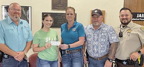 Shown as representatives of the Fayette County Sheriff’s Office presented Turtle Wing Foundation with a check in the amount of $876.94 are (from left) Lt. David Beyer; Destiny Siptak, executive director, Turtle Wing Foundation; and Sgt. Angela Lala, Investigator Marc Bennett and Deputy Herman Olvera.