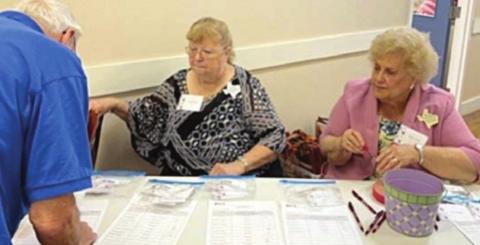 SERVING AS HOSTS AT THE REGISTRATION TABLE for the 2022 District 11 Extension Education Spring Conference held in La Grange were Janice Alexander and Carolyn Fritsche, Fayette County Extension Education Association members.