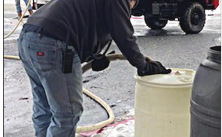 Schulenburg Volunteer Fire Department firefighters Gary Eudy (foreground) and Johnny Guerrero use Brush 4 to fill up barrels with water at Monument Hill Nursing Center last week.