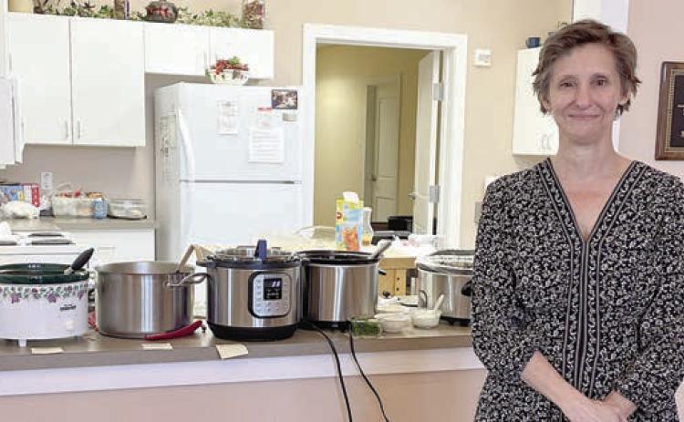 Guest sp eak er was Dawn Orsak, who is authoring a book of Texas Czech foods. She stands in front of pots of soups served at the social.