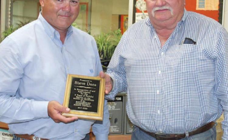 Schulenburg ISD Board of Trustees President Craig Schulz (left) presents outgoing trustee Steve Dees a plaque at Monday night’s meeting in appreciation of his service to the district over the past five years. In addition, Tony Shank (not present) was recognized for serving as a trustee for the last three years. Sticker Photo By Darrell Vyvjala