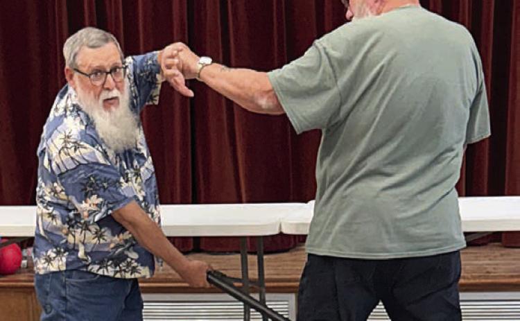 Demonstrating self-defense techniques to members in Weimar was David MaCall (left). This was just a taste of the program he will put on in the near future. David Wyman (right) was kind enough to help with the demonstration.