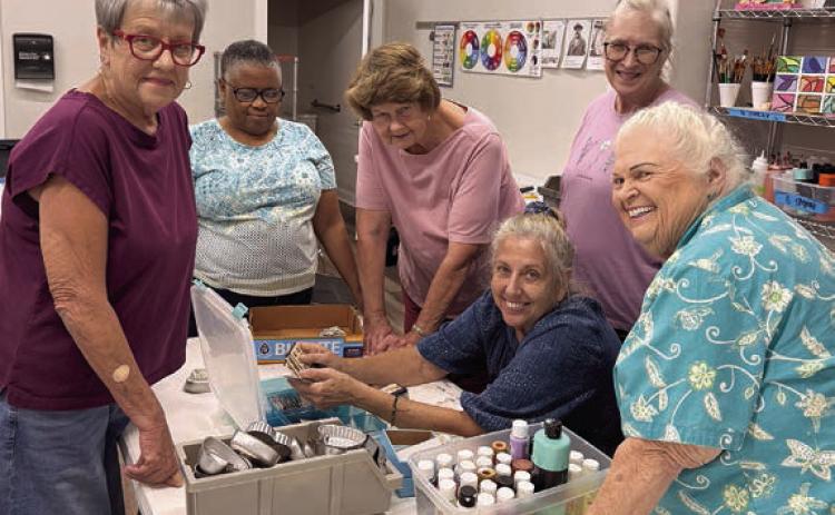 A group of art students surround Diana Chafin (seated) during her assemblage class, a big hit on Artful Fridays. The students enjoy digging through the masses of cast of items and scraps to make “found-object” sculptures. Viewing Chafin’s secret stash of special buttons are (standing, from left) Sheryl Tumis, Janice Collins, Delores Bittner, Cindy Ferguson and Glenda Genzer. The classes are made possible through Senior Connections’ partnership with Arts for Rural Texas.