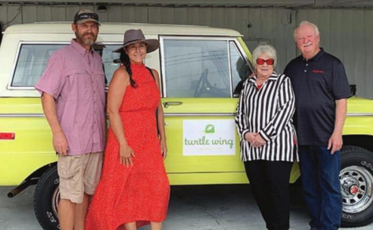 Betty and John Burkland (right) donated a 1972 Ford Bronco which was raffled to benefit Turtle Wing Foundation. The winner was Julie Shumney (second from left) and also shown is Andy Slater (left).