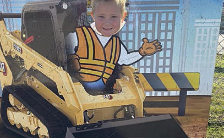 Getting in the spirit is Miles Krenek, who poses in a cutout at Dig World in Katy.