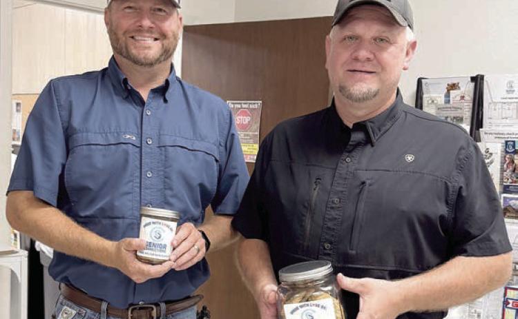Cookies – Drew Brossmann (left), Fayette County Precinct 4 Commissioner, and Paul Zapalac (right) Precinct 4 Justice of the Peace, hold cookies baked by members for cookie roundup. These goodies are then gifted to speakers and bingo callers who make the Senior Connections world go around!