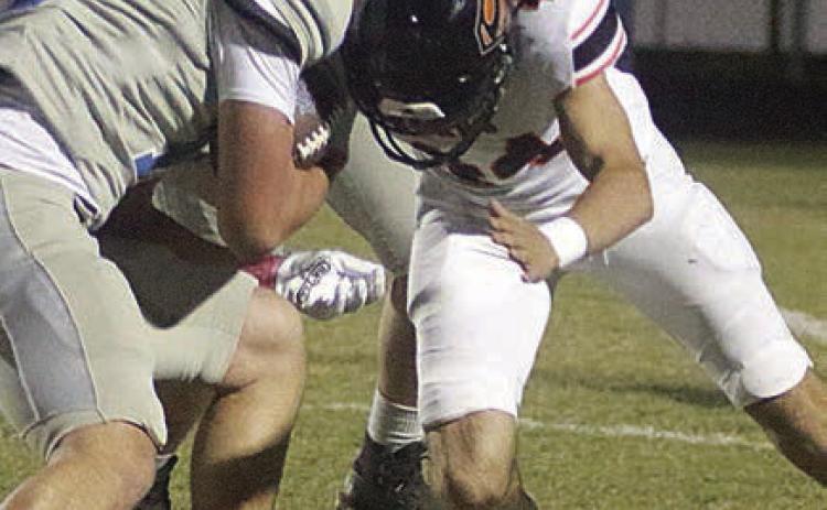 Koi Prihoda makes a fourth-down stop in the first quarter. Sticker Photo By Darrell Vyvjala