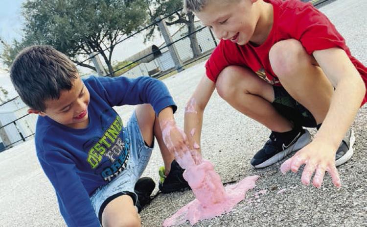 During last week’s STEM project at the Schulenburg Unit of the Boys &amp; Girls Club, members mixed baking soda, vinegar and food coloring to make fizzing Halloween magic potions. It was a spooky good time! Shown are Club members Valdemar Pineda (left) and Braxton Spradley (right).