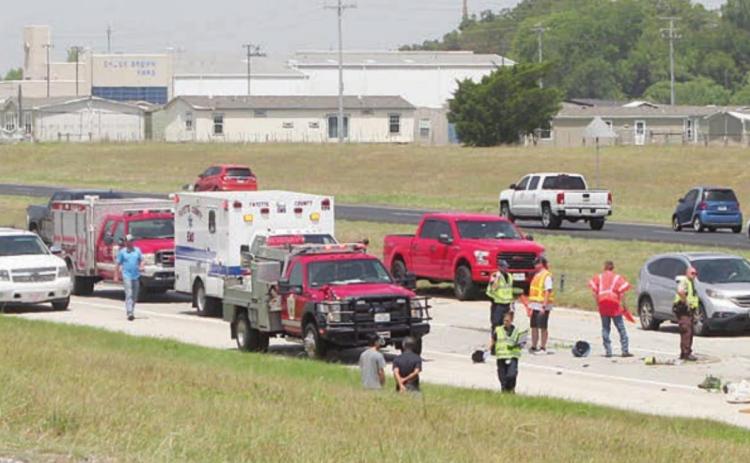 First responders work the accident on Interstate 10 eastbound just east of the Schulenburg exit near midday this past Sunday, when an overturned SUV snarled traffic for some 40 minutes. Sticker Photo By Darrell Vyvjala