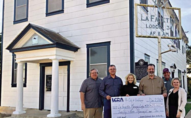 A $25,000 grant was presented by LCRA representatives to La Fayette Masonic Lodge 34 for improvements to its historic building as part of LCRA’s Community Development Partnership Program. Shown are (from left) Jeffrey L. Messer, lodge junior warden; Scott Noles, lodge worshipful master; Margaret D. “Meg” Voelter, LCRA board member; Jerry Meek, lodge secretary; Matthew L. “Matt” Arthur, LCRA board member; and Kate Ramzinski, LCRA regional affairs representative.