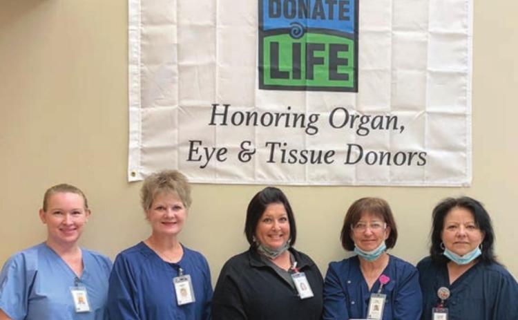 A “DONATE LIFE” banner honoring organ, eye and tissue donors hangs at St. Mark’s Medical Center. Standing in front of it are team members (from left) Jenifer Leyendecker, director of surgical and ambulatory care services; Tammy Hartfield, chief clinical officer; Amanda Fuchs, director of laboratory services; Kim Lookingbill, emergency services director; and Laurie Quitta, MedSurg director.