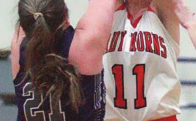 Morgan Marburger defects a Thrall pass in the second half. Sticker Photo By Darrell Vyvjala
