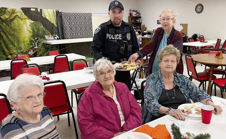 Schulenburg Police Department Officer Chris Kalina (back left) receives a platter of cookies from some of the members at Senior Connections. Present that day were (front row, from left) Clara Christ, Cynthia Meyer, Judy Klesel, and (back right) Aileen Kasper.
