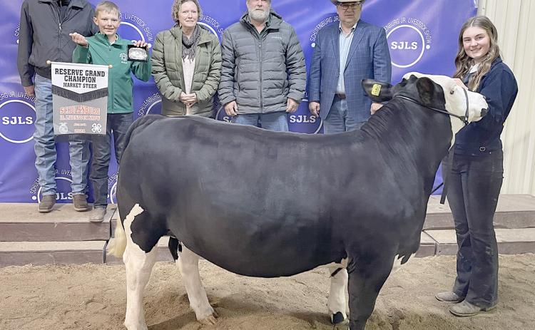 RESERVE CHAMPION MARKET STEER – Exhibitor: Madyson Holub (right). Weight: 1,235 pounds. Sales price: $9,000. Sticker Photo By Darrell Vyvjala