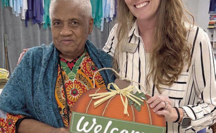 The lucky blackout winner in the bingo game called by Chyla Podhajsky (right) with Wellsential Nursing &amp; Rehab in Hallettsville was Kathy Moore (left). This prize had many members dreaming of fall temperatures.