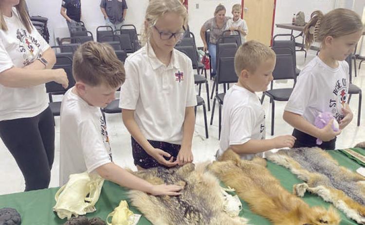 Checking out pelts are (from left) Kristy Novick, Hudson Novick, Penny Bartek, Miles Krenek and Addy Johnson.