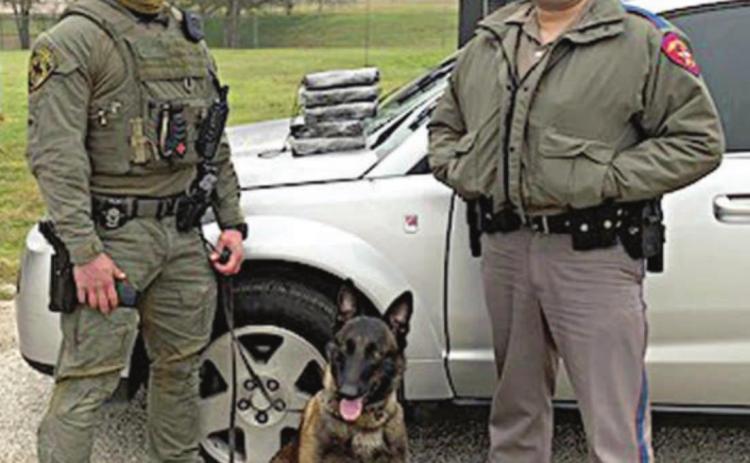 Sgt. Randy Thumann, his K-9 partner Kolt and DPS Trooper Josh Berger with five bricks of cocaine located in a Saturn Vue during a traffic stop on Interstate 10 near Engle.