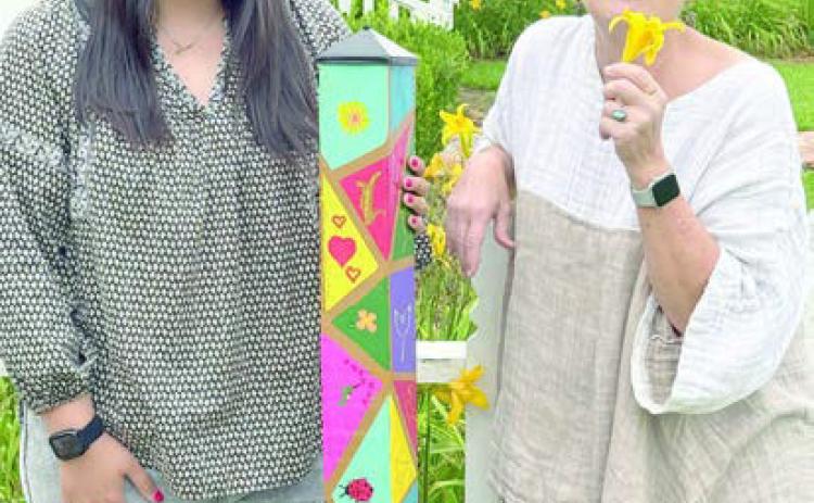 A garden pole was presented to Stanzel Family Foundation, represented by Melanie Ramirez (left), as a gift for its support of Senior Connections, represented by program director Stephanie Shroyer (right).