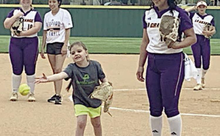 Kylie throws out the first pitch at the La Grange softball team’s Turtle Wing Game on April 1.