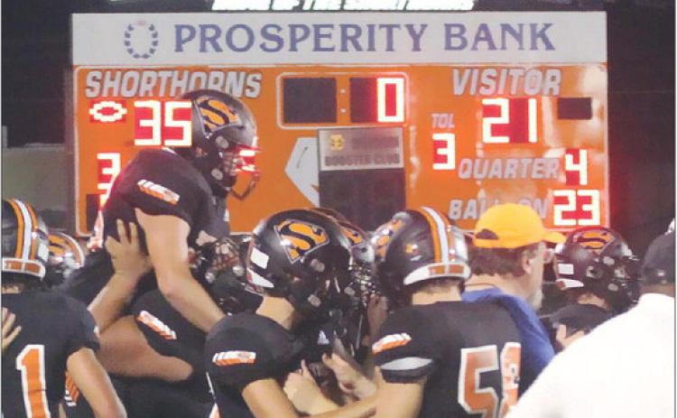 Shorthorn players congratulate each other following last Friday’s 35-21 win to end a losing streak that reached 13 games. Sticker Photo By Layne Vyvjala