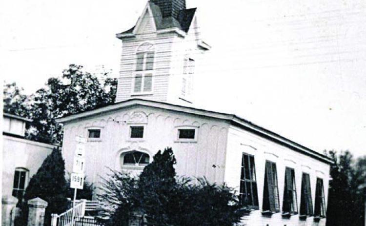 Union Church with the shutters of five large widows on the west side tilted open for air circulation. There are also three small windows across the upper front. Photo Courtesy of First Presbyterian Church