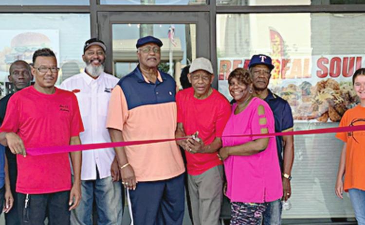 Real Deal Soul Food cuts ribbon